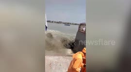 Boat ferrying travellers gets caught in massive high tide in eastern India