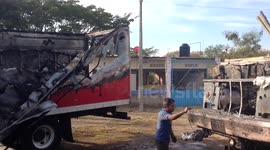 Burnt-out lorries following protests in Iguala, Mexico