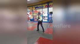Security guard shows off dance moves outside supermarket