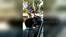 Men drink beer on tractor while canvasing for prohibition candidate in India