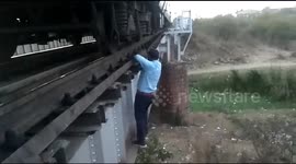 That's dedication! Brave train driver risks life to fix train after it stops on bridge in central India