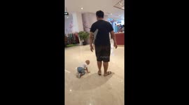 exhilarating the fun of playing at the mall, a toddler does something funny at Malang mall, Indonesia