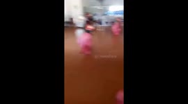 The children sit in the sack and try to move to the destination