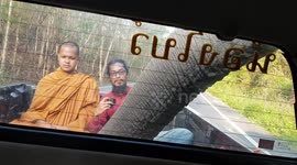 Terrified Buddhist monk looks on nervously as wild ELEPHANT raids pickup truck