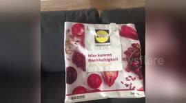Man tries to press buttons on carrier bag in funny design fault