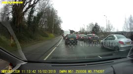 Dangerous driver uses footpath as traffic lane during UK gridlock