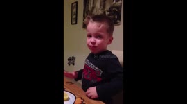 Young boy doesn't like the taste of lemons one bit