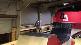 Enthusiastic BMXer lands trick and celebrates by throwing his bike around