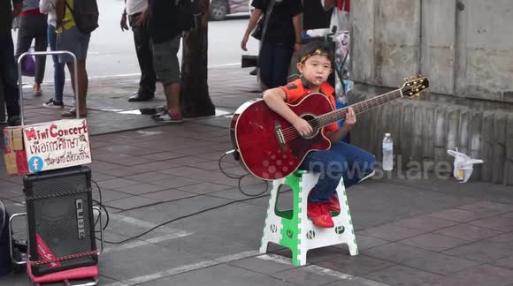Street musicians of Thailand - the little guitarist in red red shoes