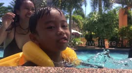 Little kid makes legendary photobomb on mother's slow-mo video