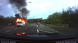 UK driver spots car engulfed in flames on commute to work