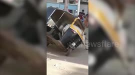 Warring bull gets stuck inside auto rickshaw in western India