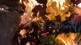 Campfire slow motion burning of pine cones and a bag of coal