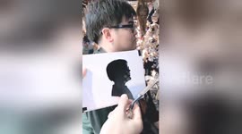 Astonishing Chinese street artist cuts paper profiles in one minute
