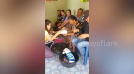 Doggy makes a splash jumping into bucket of water for Songkran