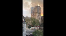 Crowds watch fire on the roof of the Notre Dame