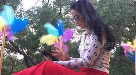 Thai girl relaxes with Computer tablet and windmills.