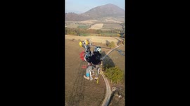 A French lineman completes his work suspended on bicycle apparatus above the ground
