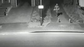 Dramatic CCTV shows yob swings pickaxe through roof of family car