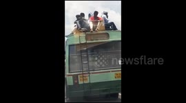 People risk their lives by traveling on bus roof due to election rush in India