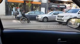 Wheelchair User Rides Through Busy Traffic