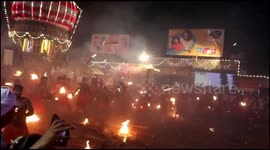 Devotess throw burning torch  at each other  in  the tradition of 'Agni Kelly' in southern India.