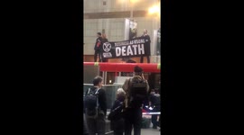 Climate change activists climb on top of DLR train at London's Canary Wharf station