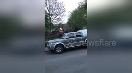 'House party for one' as man walks down street with flame-throwing shed on his head