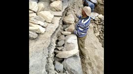 Labourers risking their life for opening road.