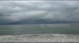 Black storm clouds seen enveloping the coastal waters of Padang
