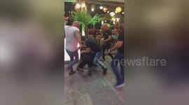 Spotlight stolen from tourist downing a pint as brawl erupts around him