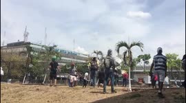  Clashes in Caracas: angry protesters try to crush a huge metal fence of the military base of Venezuela