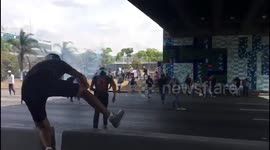  Protesters in Caracas throw stones at the National Guard motorcycle