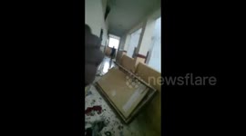 Waterlogged door bursts from frame during cyclone winds