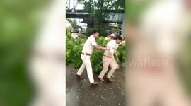 Police, rescuers remove fallen tree from road to facilitate traffic in Odisha after Fani batters state