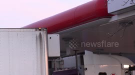 Tractor trailer in Toronto takes short cut through gas station and comes within inches of getting stuck under canopy