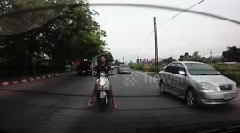 Moped rider in Thailand smashes 'rear windscreen with his head' then rides off