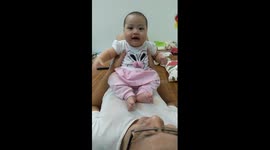 Baby girl laughing on Daddy's body