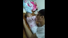 Baby girl removing her father's glasses