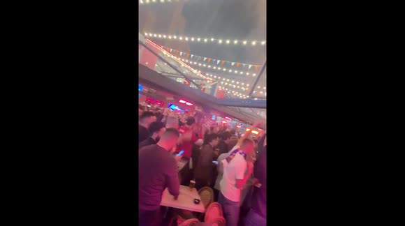 Liverpool fans in Concert Square celebrate their incredible win over Barcelona
