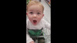 Toddler loves flying around in shopping trolley
