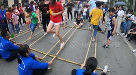 Vietnamese public take part in bamboo dancing in the streets of Hanoi