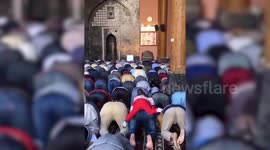 Watch playful girl riding on devotee's back during prayer inside mosque in northern India