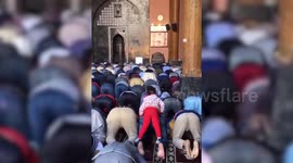 Watch playful girl riding devotee's back during prayer inside mosque in northern India