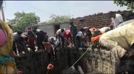 Indian families fetch water from 50-foot well in drought-hit village
