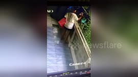 Woman hilariously falls over balcony trying to gather laundry