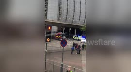 Overturned ParcelForce lorry that fell off bridge onto roundabout