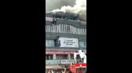 People jump from building for their lives during major fire in Indian city of Surat