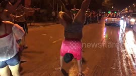 Exuberant man celebrates Thai New Year by performing dance routine in the middle of road