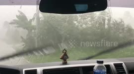 Huge hailstones batter cars during unseasonal storm in the Philippines